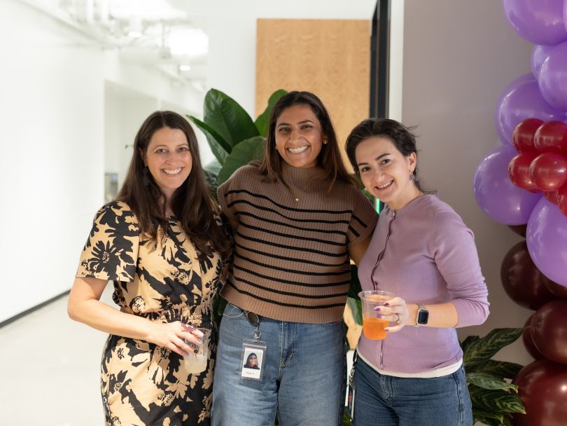 Three Superhuman team members pose for a photo during a company event